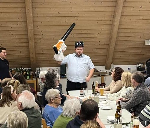 Christopher Herzog als Auktionator in Aktion (Mitte), flankiert von Kassier Ronnie Kinast (links)